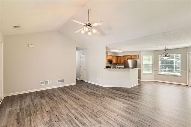 230 Belmont Trl, Covington, GA 30016 - unfurnished living room featuring dark wood-style flooring, a ceiling fan, and lofted ceiling