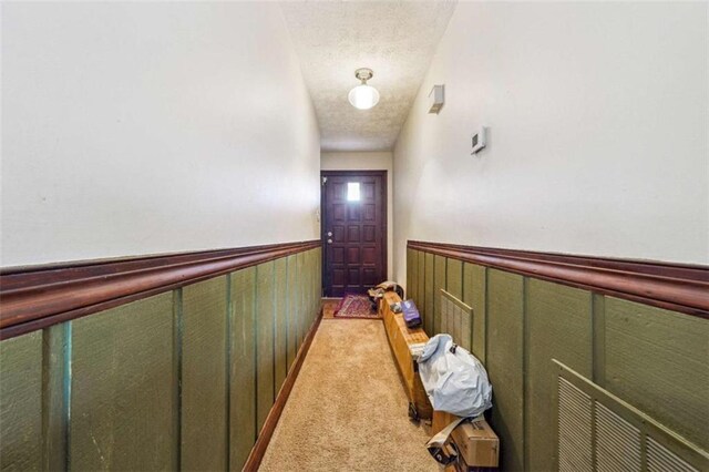 270 Oak Ridge Rd, Covington, GA 30016 - hall with a wainscoted wall, light colored carpet, and a textured ceiling