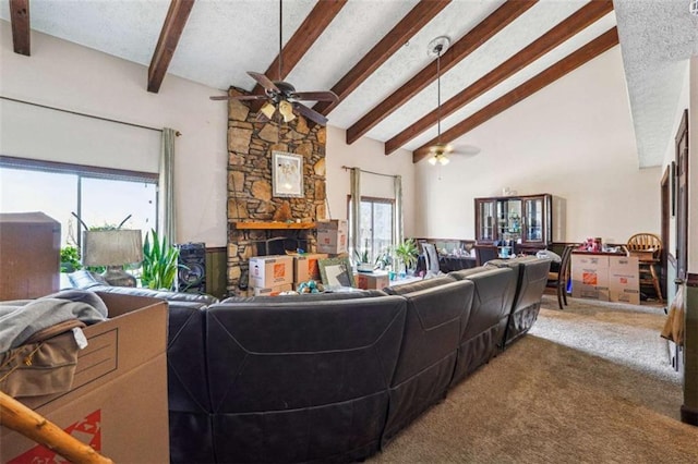 270 Oak Ridge Rd, Covington, GA 30016 - carpeted living room featuring beamed ceiling, high vaulted ceiling, ceiling fan, and a textured ceiling