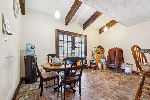 270 Oak Ridge Rd, Covington, GA 30016 - dining room with stone finish flooring, french doors, lofted ceiling with beams, a textured ceiling, and baseboards