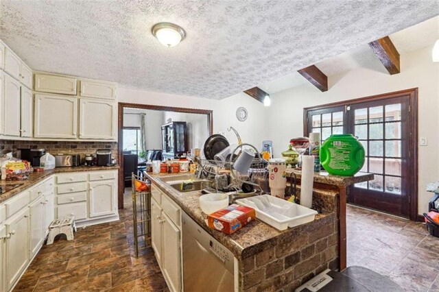 270 Oak Ridge Rd, Covington, GA 30016 - kitchen with a textured ceiling, a kitchen island with sink, stainless steel dishwasher, a sink, and backsplash