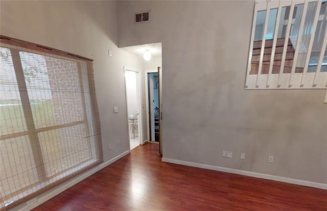 spare room with dark wood-type flooring