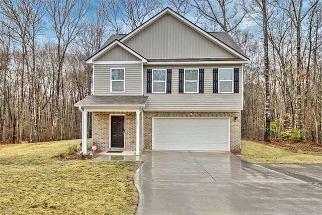 view of front of home featuring concrete driveway, a garage, brick siding, and a front yard