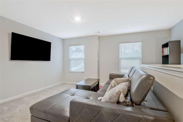 living area with baseboards and carpet