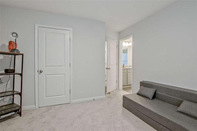 sitting room featuring carpet flooring and baseboards