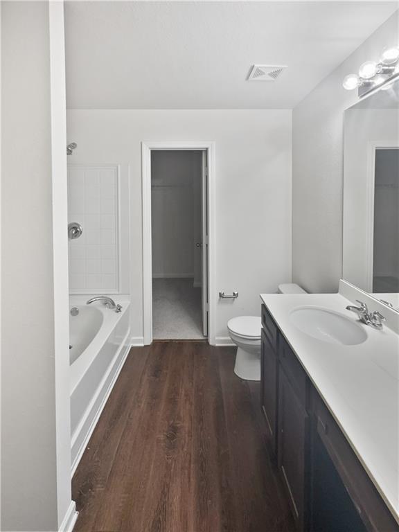 bathroom featuring vanity, toilet, and hardwood / wood-style flooring