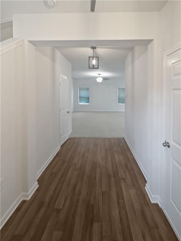 corridor featuring dark hardwood / wood-style floors