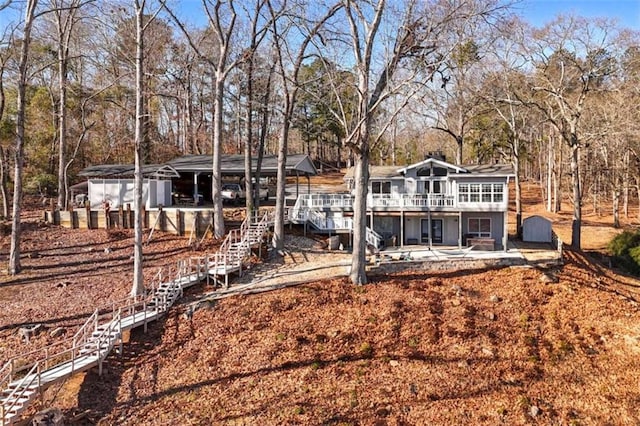 rear view of property featuring a patio and a deck