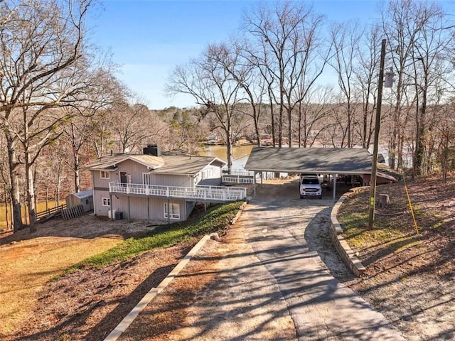 view of front facade with a carport and a water view