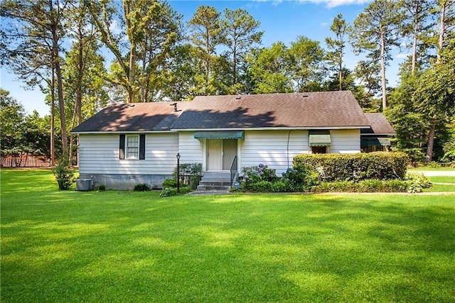 view of front of property featuring cooling unit and a front lawn