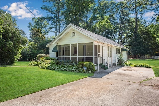 view of front of property with a front lawn and a sunroom