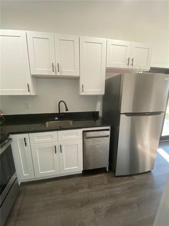 kitchen featuring white cabinetry, sink, dark wood-type flooring, and appliances with stainless steel finishes