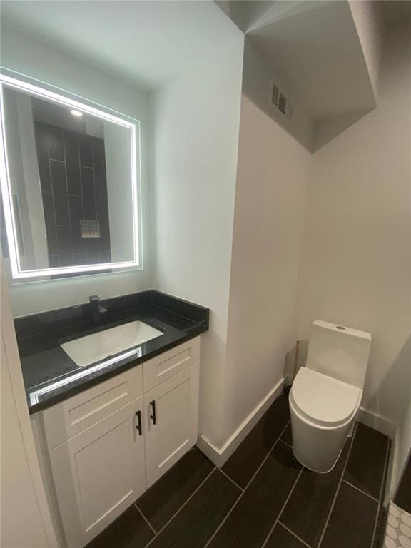 bathroom featuring vanity and toilet