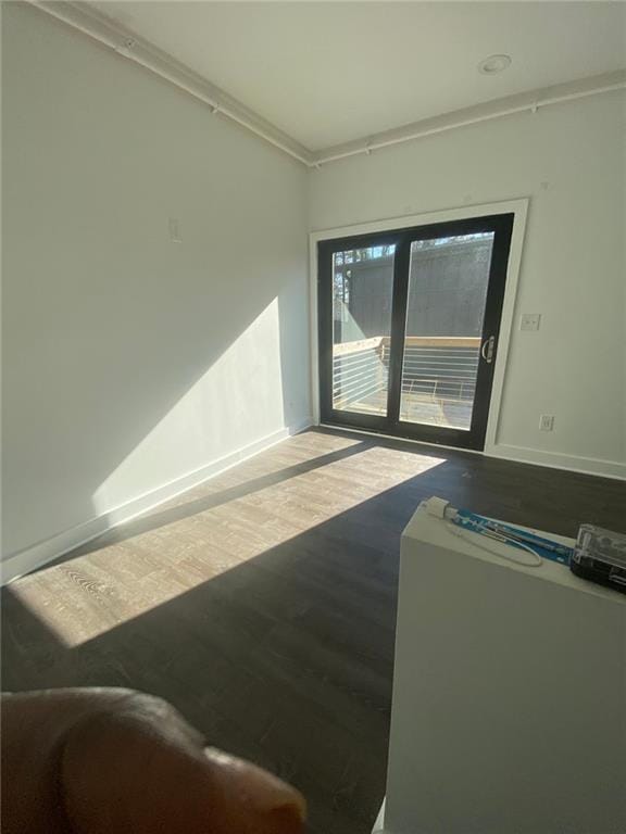 interior space featuring hardwood / wood-style flooring and ornamental molding