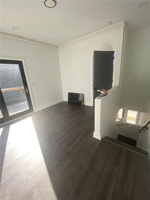 empty room featuring dark hardwood / wood-style floors and ornamental molding