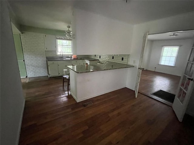 15 Liberty St, Gainesville, GA 30501 - kitchen with a peninsula, healthy amount of natural light, dark wood-type flooring, and backsplash