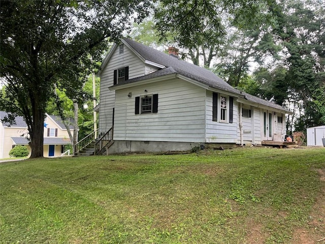 15 Liberty St, Gainesville, GA 30501 - view of side of property with a chimney, a shed, a lawn, and roof with shingles