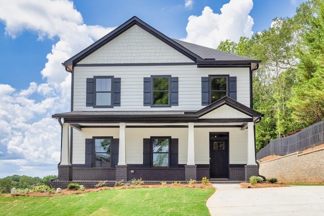 craftsman house featuring a porch and a front yard