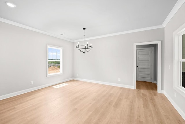 unfurnished room with crown molding, a chandelier, and light wood-type flooring