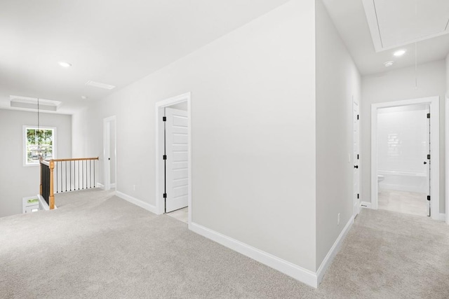 hall featuring light colored carpet