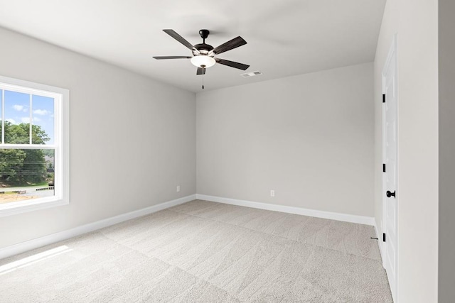 spare room featuring ceiling fan and light carpet