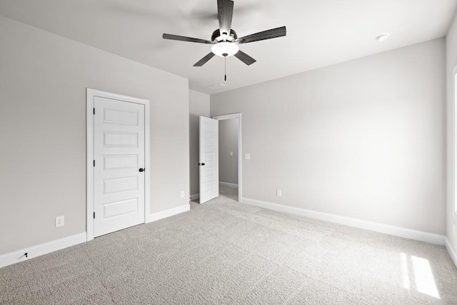 unfurnished bedroom featuring light carpet and ceiling fan