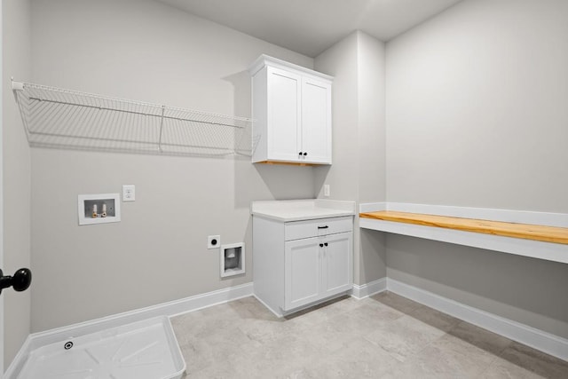 clothes washing area with washer hookup, hookup for an electric dryer, and cabinets