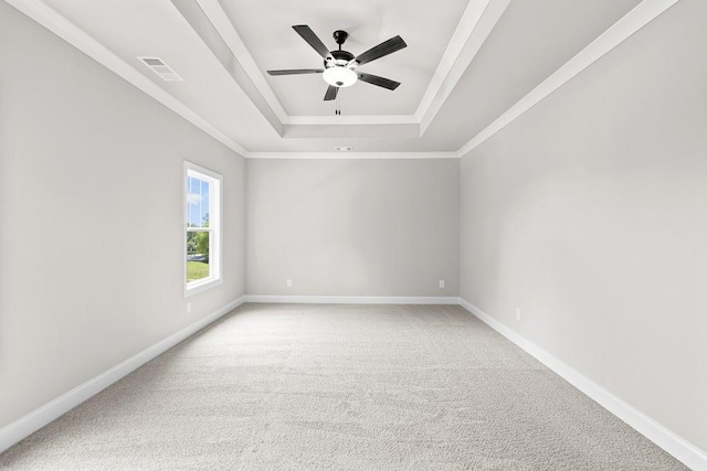 unfurnished room with ceiling fan, carpet flooring, crown molding, and a tray ceiling