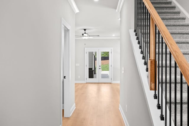 hall with french doors and light hardwood / wood-style flooring