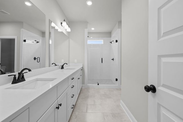 bathroom with tile patterned floors, a shower with door, and vanity