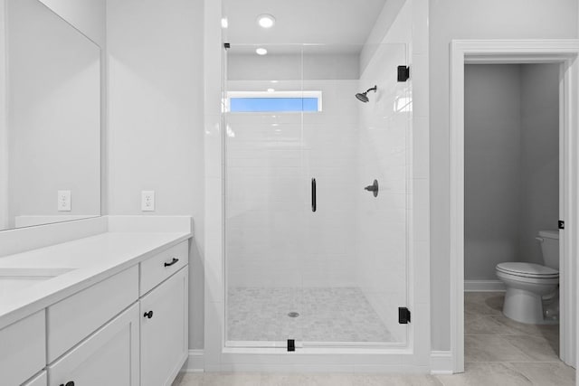 bathroom featuring vanity, toilet, tile patterned floors, and a shower with door