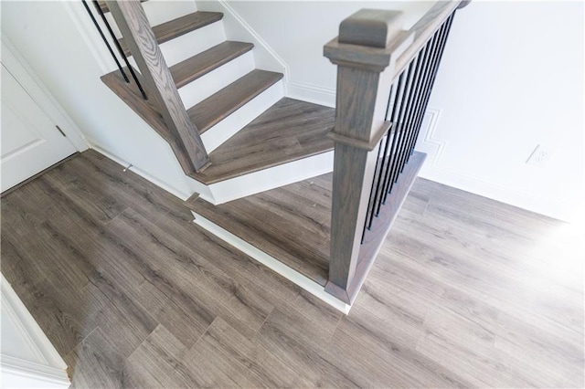 stairs featuring hardwood / wood-style flooring