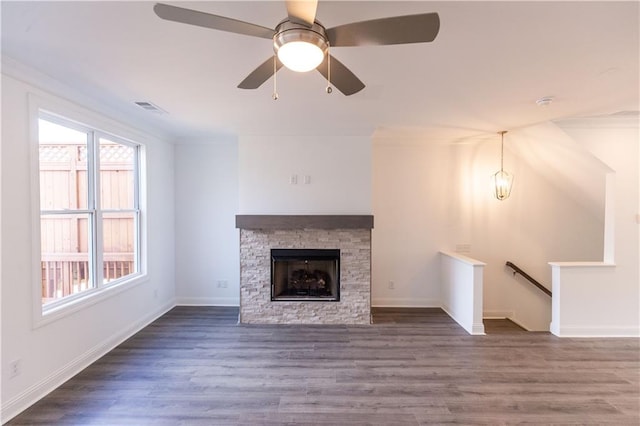 unfurnished living room featuring dark hardwood / wood-style flooring, a fireplace, ceiling fan, and ornamental molding