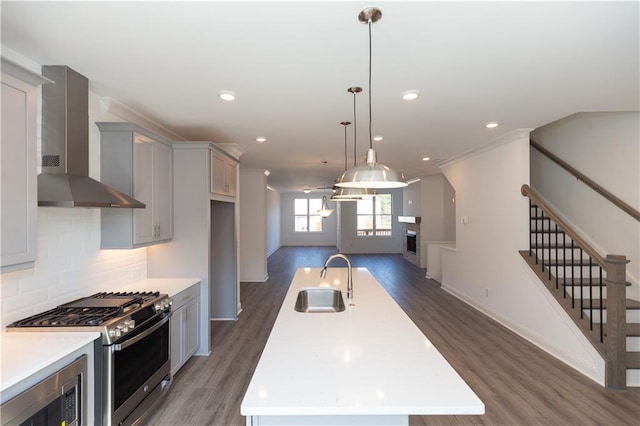 kitchen with sink, wall chimney exhaust hood, a kitchen island, double oven range, and built in microwave