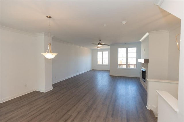 unfurnished living room featuring ceiling fan, crown molding, and dark hardwood / wood-style floors