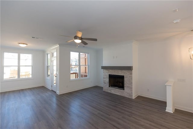 unfurnished living room with a fireplace, ceiling fan, crown molding, and dark hardwood / wood-style flooring