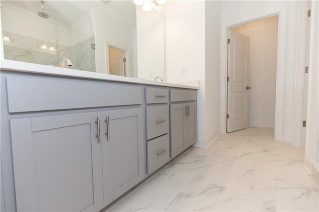 bathroom with walk in shower and vanity