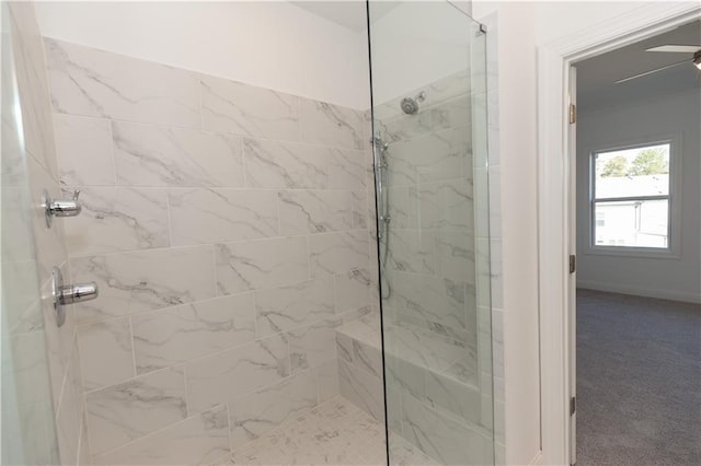 bathroom with ceiling fan and tiled shower