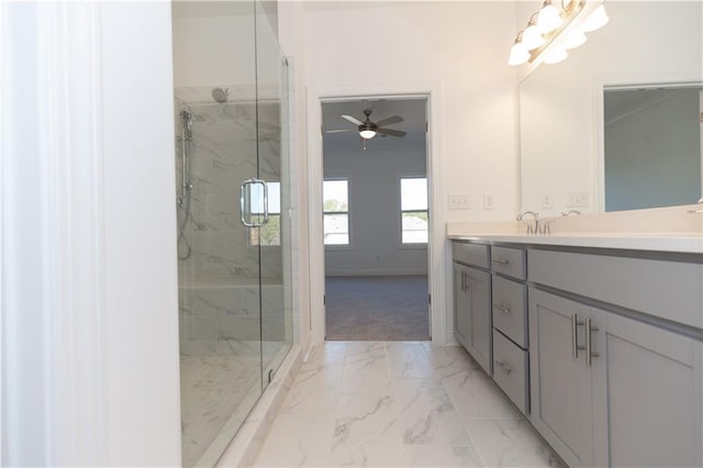 bathroom featuring an enclosed shower, ceiling fan, and vanity