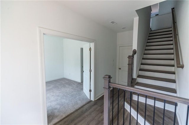 stairs featuring hardwood / wood-style floors