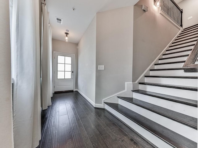 foyer featuring visible vents, stairway, baseboards, and dark wood-style flooring