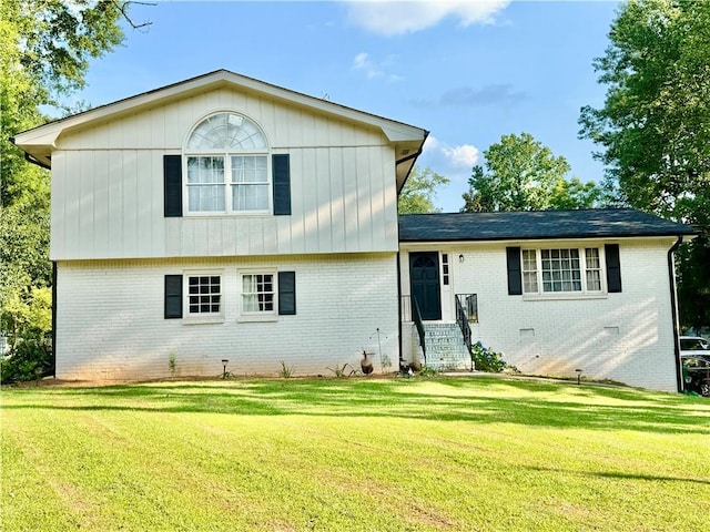 5347 Ocarol Ct, Stone Mountain, GA 30088 - split level home featuring brick siding, a front yard, and entry steps