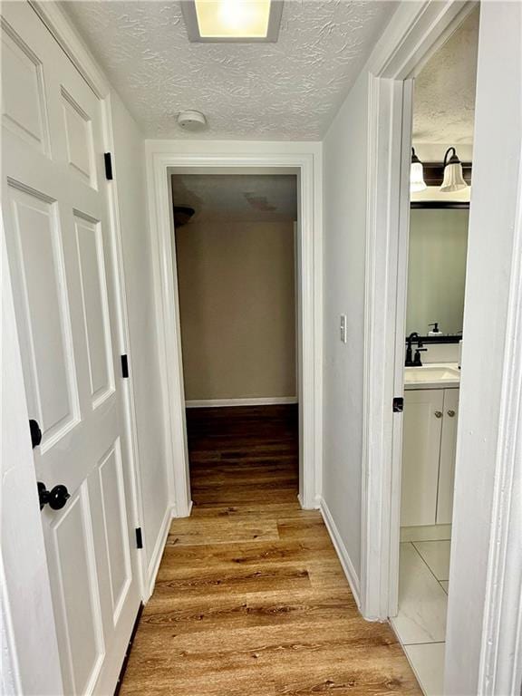 5347 Ocarol Ct, Stone Mountain, GA 30088 - hallway featuring a textured ceiling and light wood-style flooring