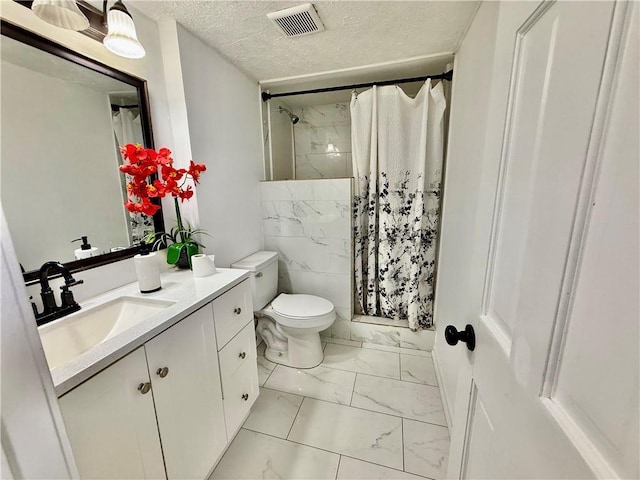 5347 Ocarol Ct, Stone Mountain, GA 30088 - bathroom with marble look tile flooring, vanity, curtained shower, and a textured ceiling