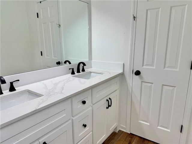 5347 Ocarol Ct, Stone Mountain, GA 30088 - bathroom featuring double vanity and wood finished floors