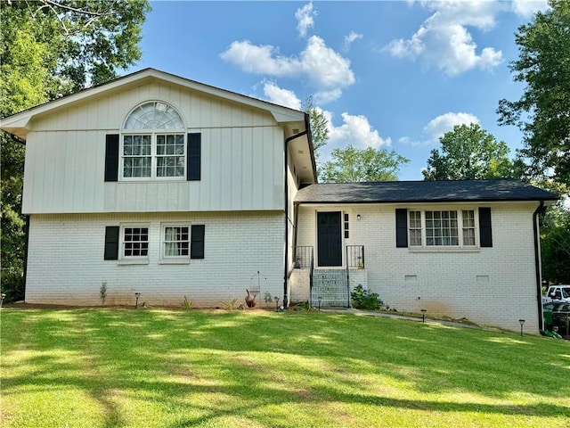 5347 Ocarol Ct, Stone Mountain, GA 30088 - tri-level home featuring a front yard and brick siding