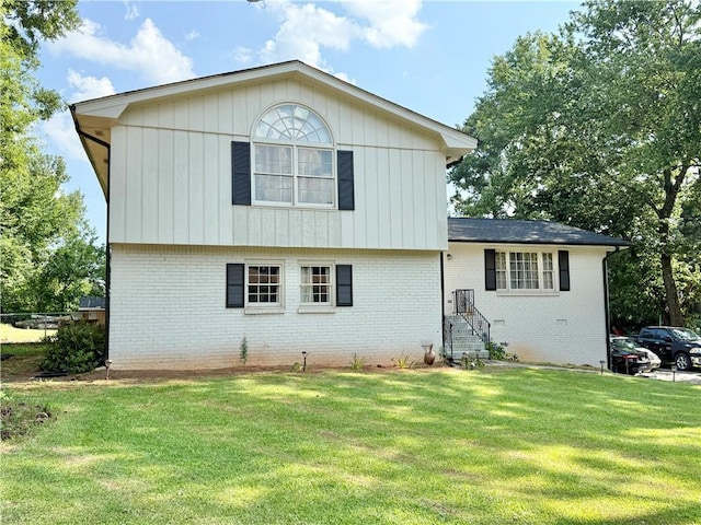 5347 Ocarol Ct, Stone Mountain, GA 30088 - back of house featuring brick siding and a lawn