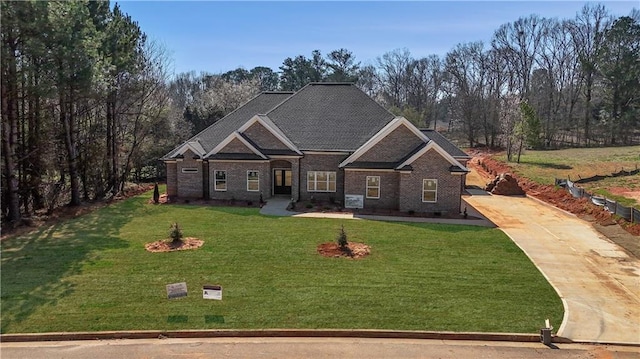 craftsman-style house with a front lawn and brick siding