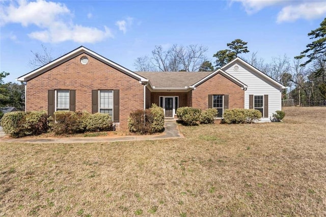 single story home featuring brick siding and a front lawn