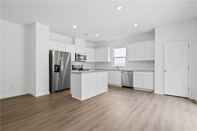 3064 Orwell Dr, Gainesville, GA 30507 - kitchen featuring appliances with stainless steel finishes, a sink, light wood finished floors, white cabinetry, and recessed lighting